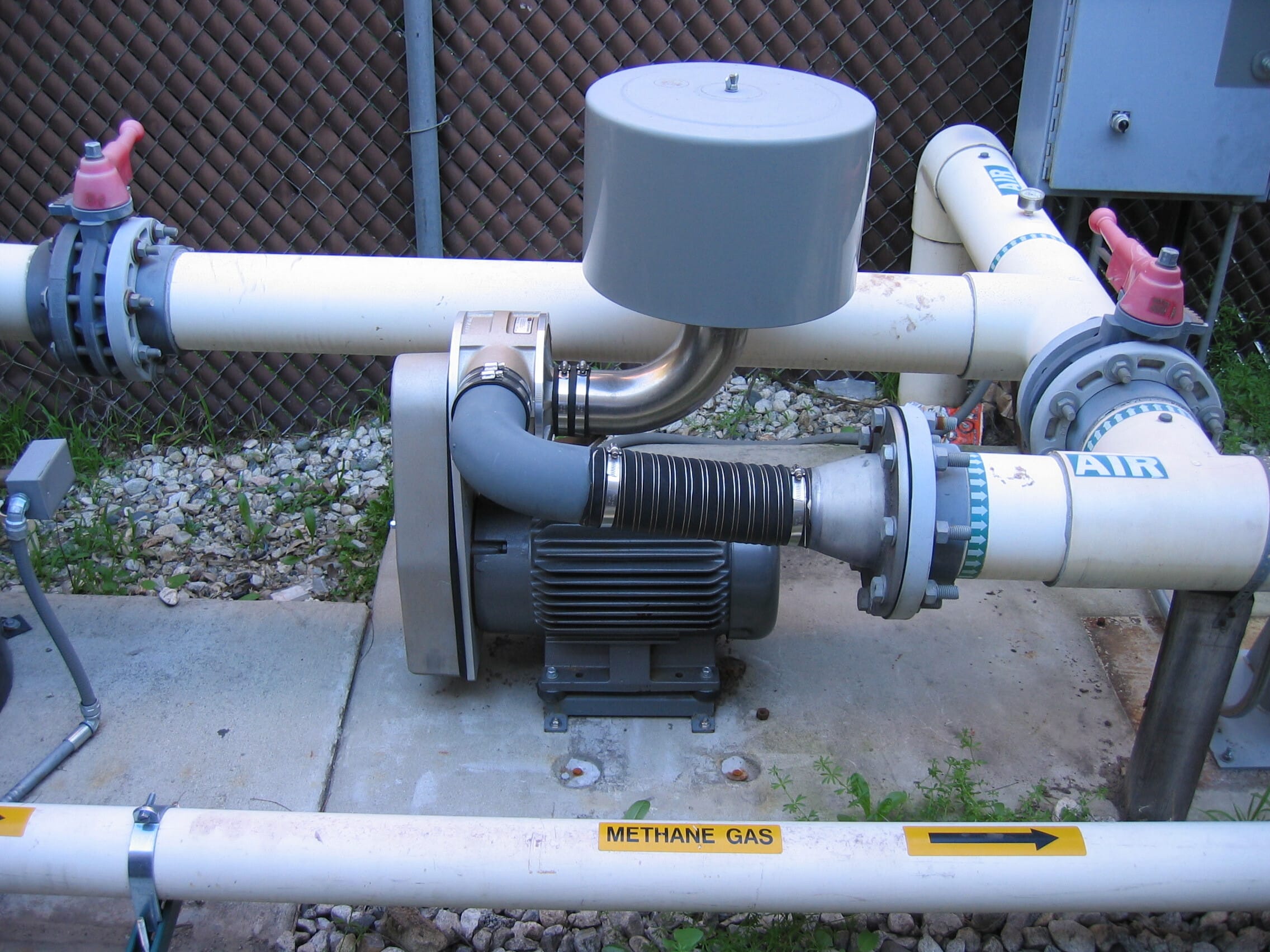 Centrifugal blower connected to air and methane gas piping at an outdoor remediation installation