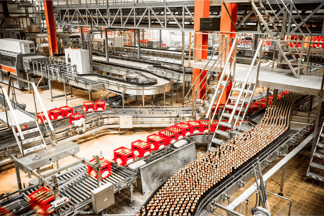 Beverage containers moving through an industrial drying process