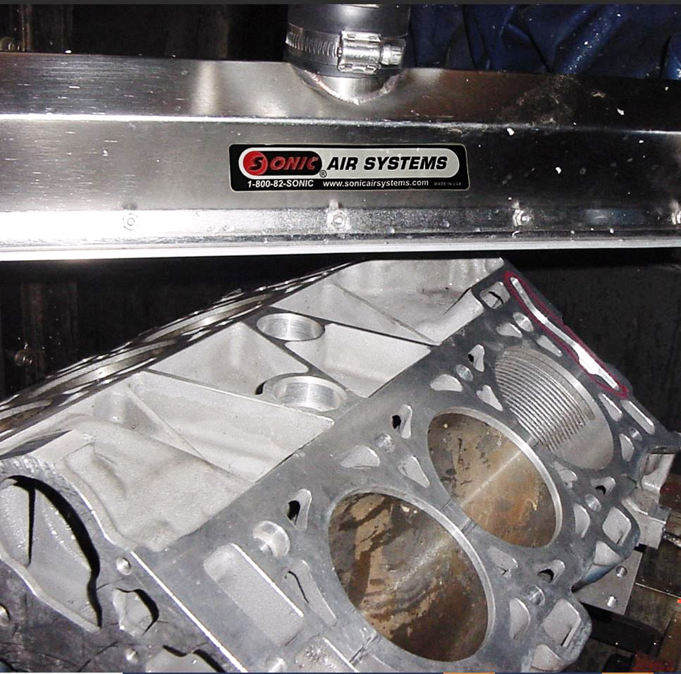 Sonic centrifugal blower powering engine block debris removal