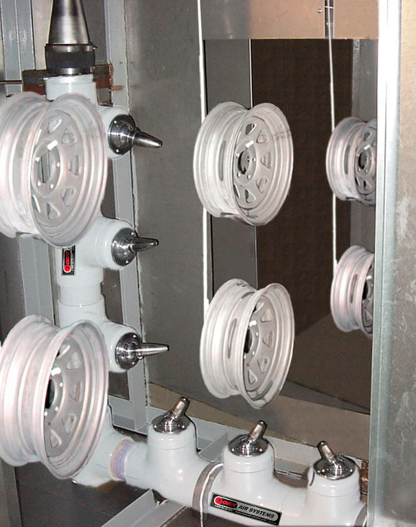 Sonic air wipe drying a wheel on a Carlisle Tire and Wheel conveyor